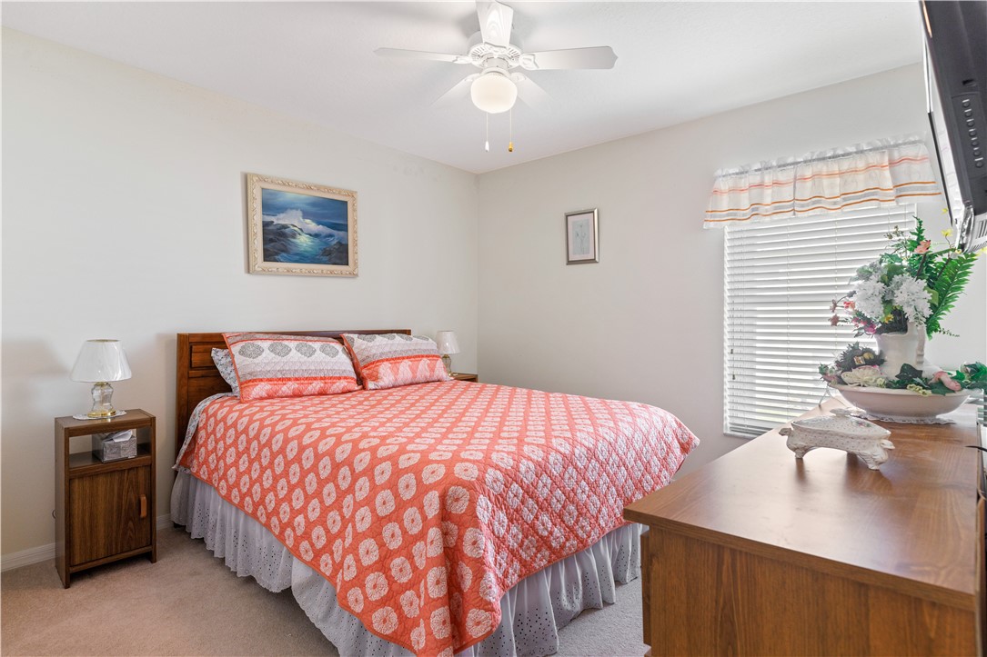 594 Cottonwood Road Sebastian, FL 32958 - Photo 11 of 27 a bedroom with a bed and a potted plant