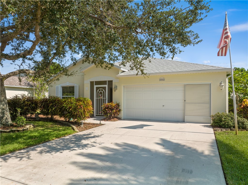 594 Cottonwood Road Sebastian, FL 32958 - Photo 20 of 27 a front view of a house with a yard and potted plants
