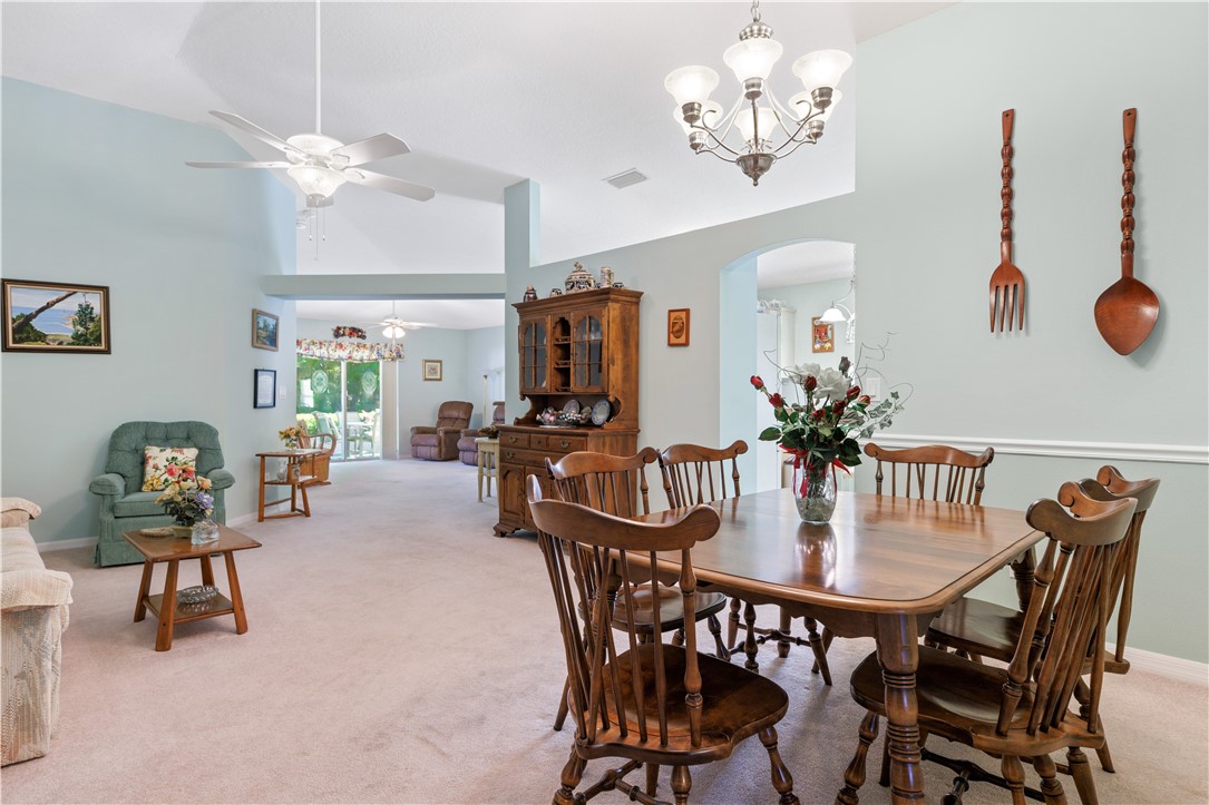 594 Cottonwood Road Sebastian, FL 32958 - Photo 3 of 27 a view of a dining room with furniture and chandelier