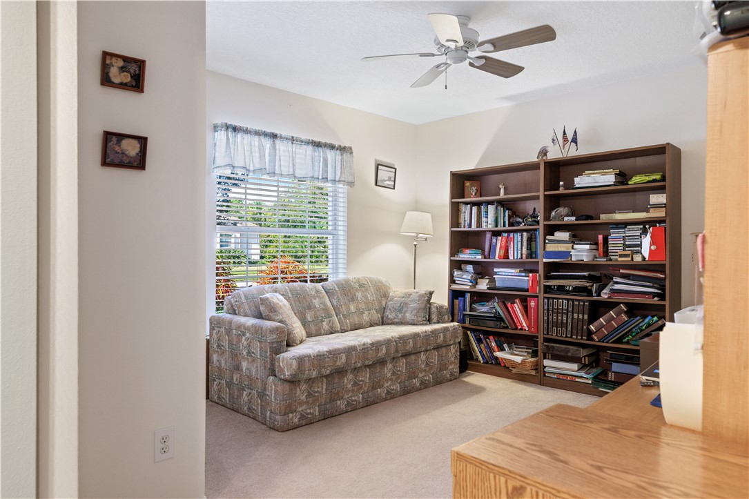 594 Cottonwood Road Sebastian, FL 32958 - Photo 8 of 27 a living room with furniture and a book shelf