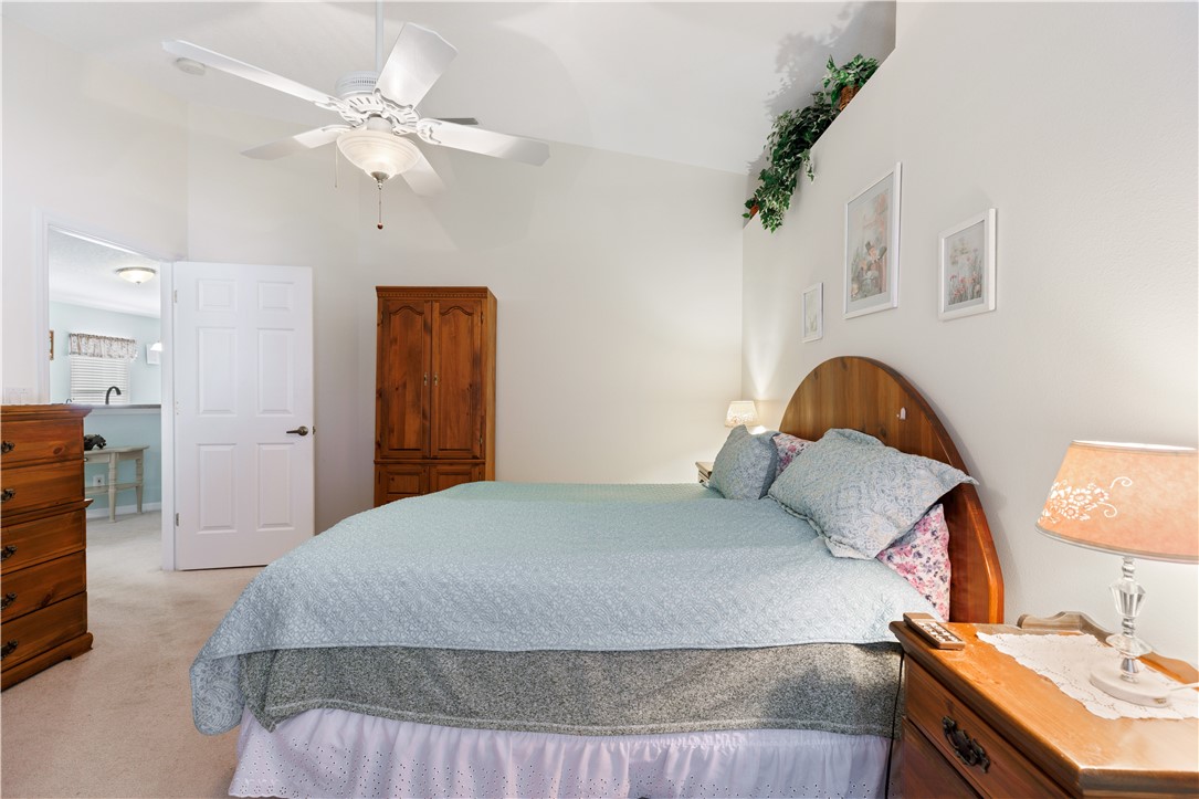 594 Cottonwood Road Sebastian, FL 32958 - Photo 9 of 27 a bedroom with a bed and a chandelier