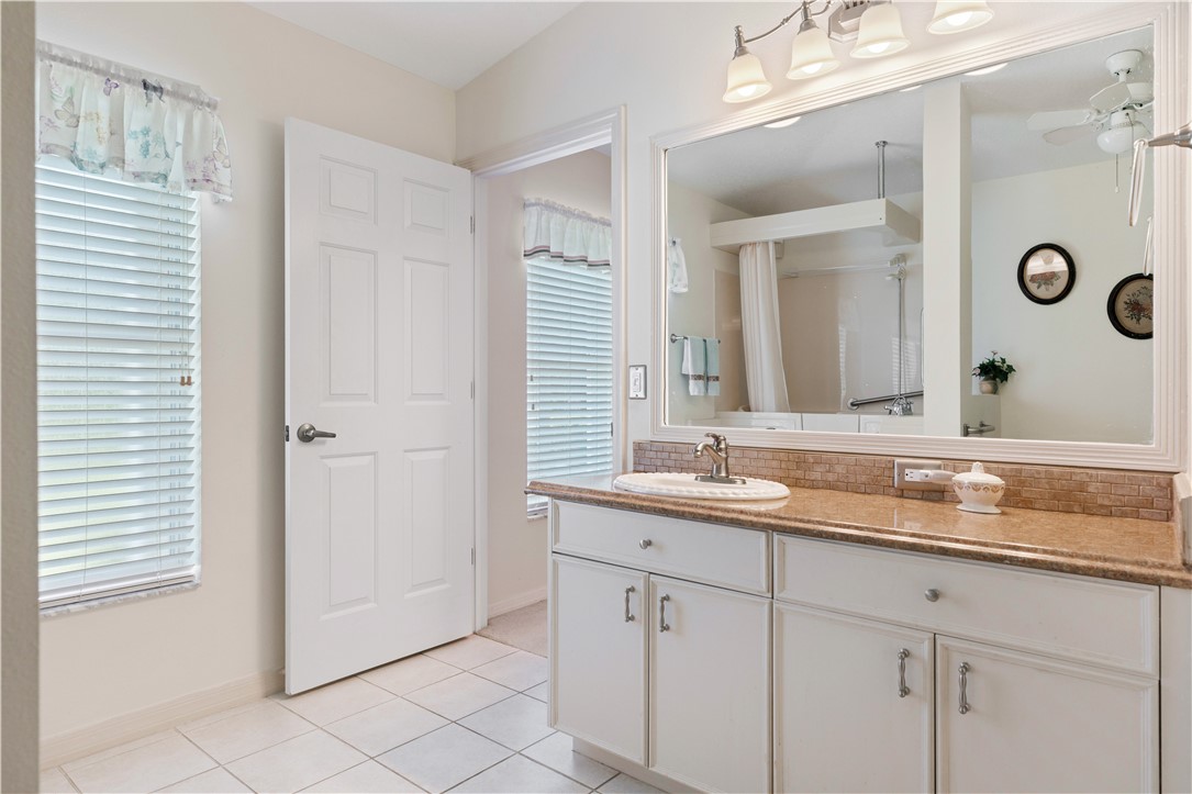 594 Cottonwood Road Sebastian, FL 32958 - Photo 10 of 27 a bathroom with a granite countertop sink and a mirror