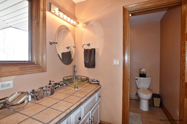 32W546 Rochefort Lane Wayne, IL 60184 - Photo 17 of 25 a bathroom with a granite countertop sink a toilet and a mirror