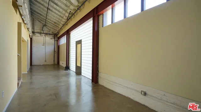 a view of a hallway with wooden floors
