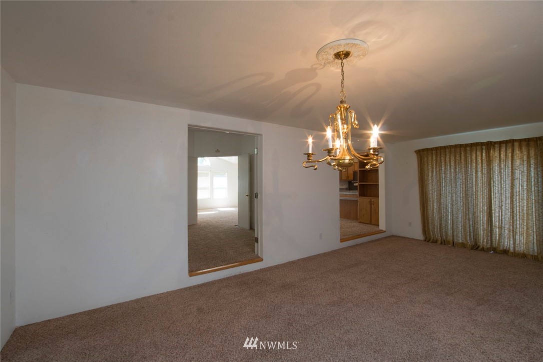 465 Guy Kelly Road Port Angeles, WA 98362 - Photo 12 of 31 a view of a chandelier in big room and chandelier