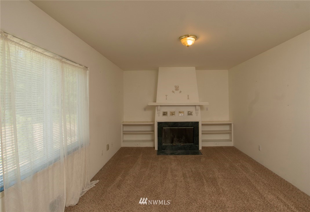 465 Guy Kelly Road Port Angeles, WA 98362 - Photo 16 of 31 a view of empty room with a fireplace