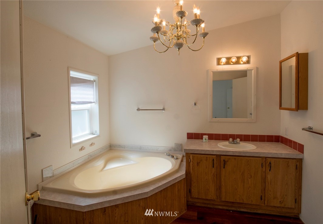 465 Guy Kelly Road Port Angeles, WA 98362 - Photo 19 of 31 a bathroom with a sink and a mirror
