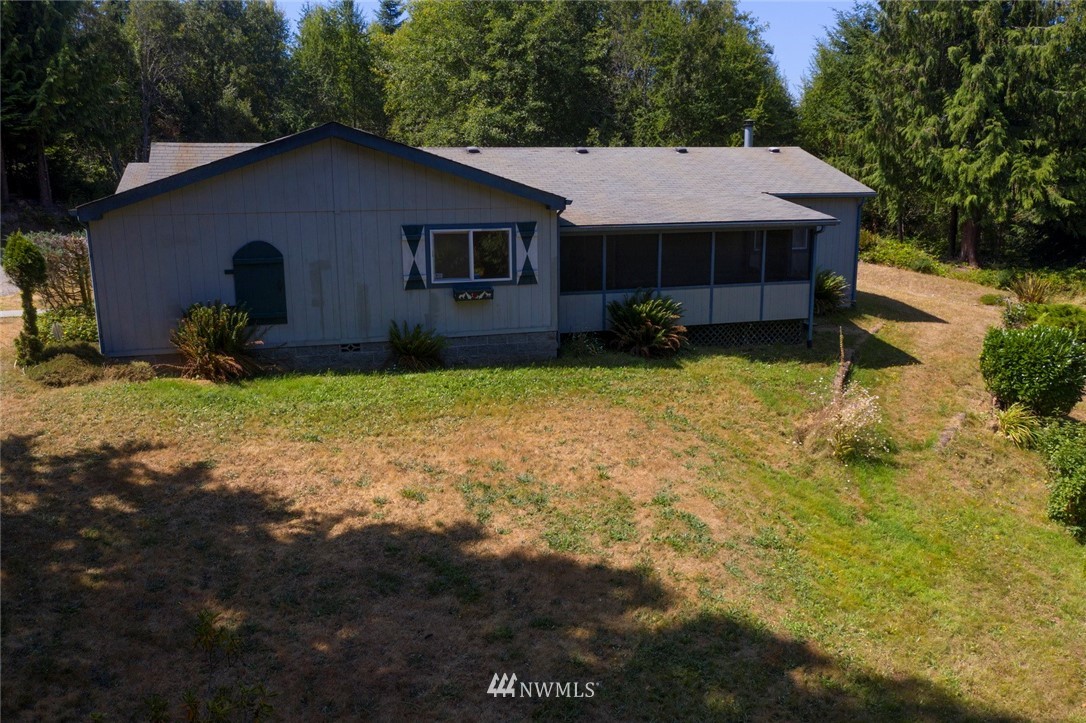 465 Guy Kelly Road Port Angeles, WA 98362 - Photo 3 of 31 a house with trees in the background