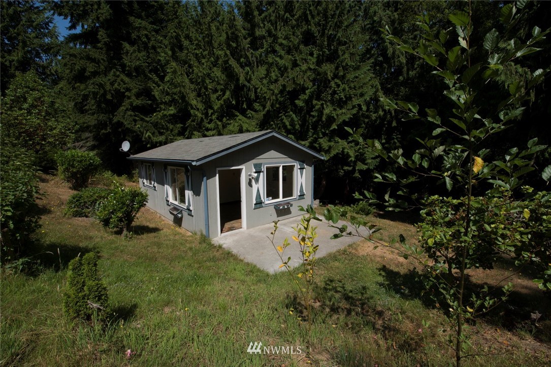 465 Guy Kelly Road Port Angeles, WA 98362 - Photo 23 of 31 a front view of a house with a yard and trees