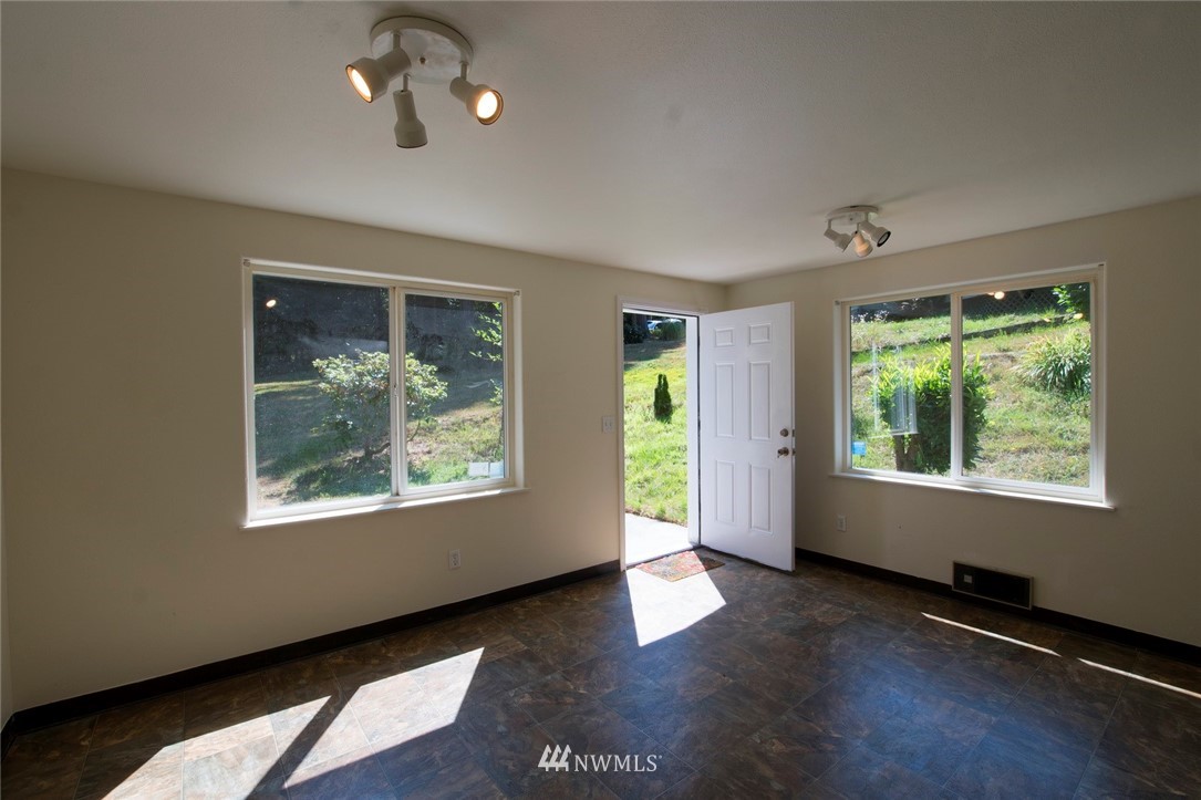 465 Guy Kelly Road Port Angeles, WA 98362 - Photo 25 of 31 a view of an empty room with wooden floor and a window