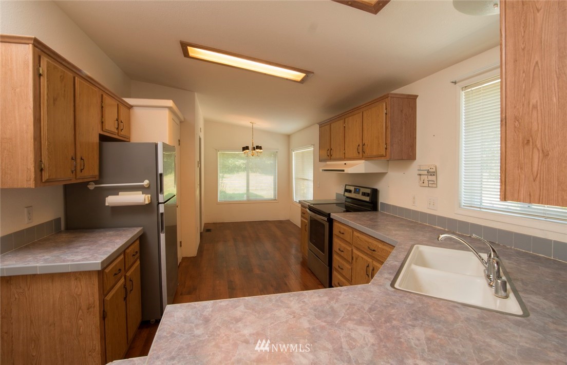 465 Guy Kelly Road Port Angeles, WA 98362 - Photo 9 of 31 a kitchen with a refrigerator stove top oven and sink