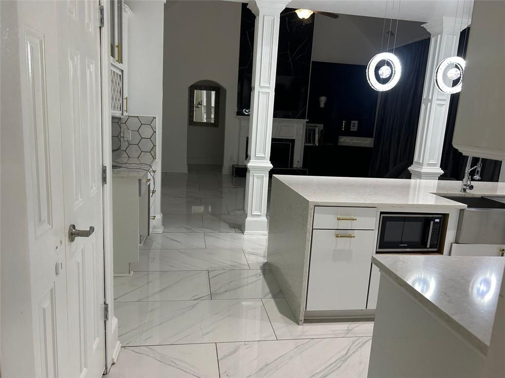 6409 Caledon Court Locust Grove, GA 30248 - Photo 3 of 7 a kitchen with stainless steel appliances granite countertop a sink and a refrigerator