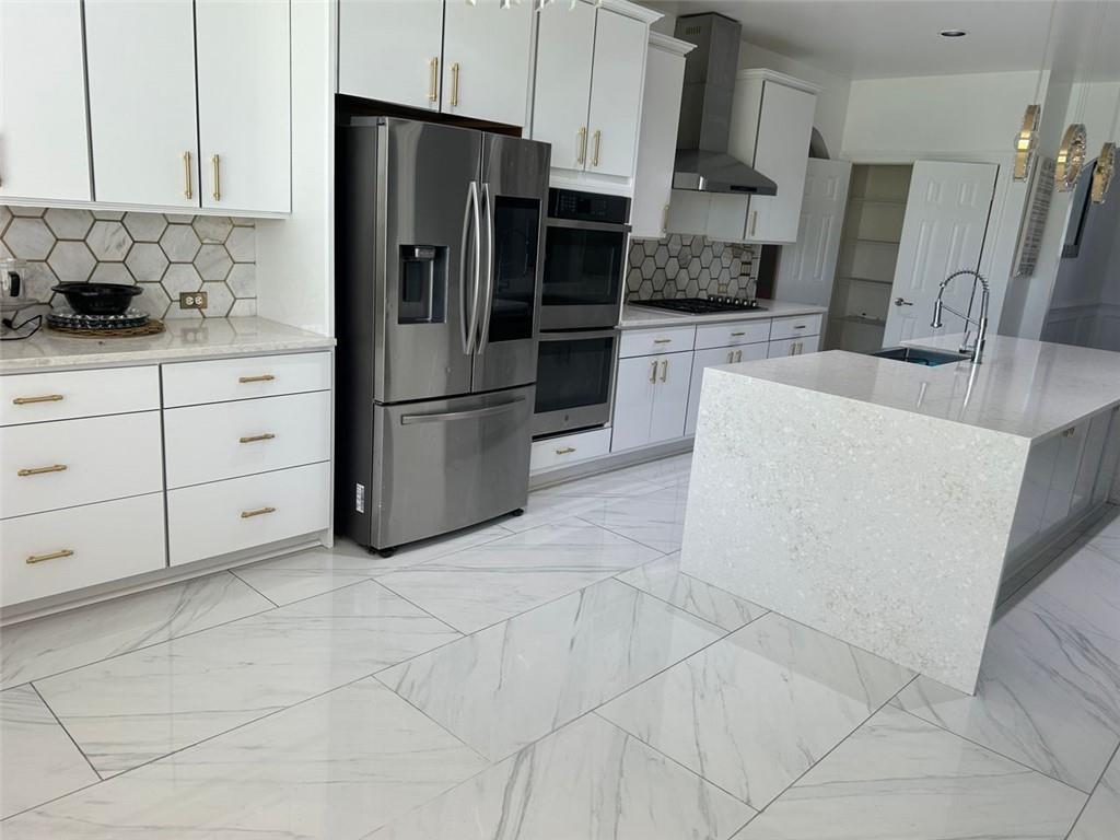 6409 Caledon Court Locust Grove, GA 30248 - Photo 7 of 7 a kitchen with stainless steel appliances a refrigerator sink and cabinets