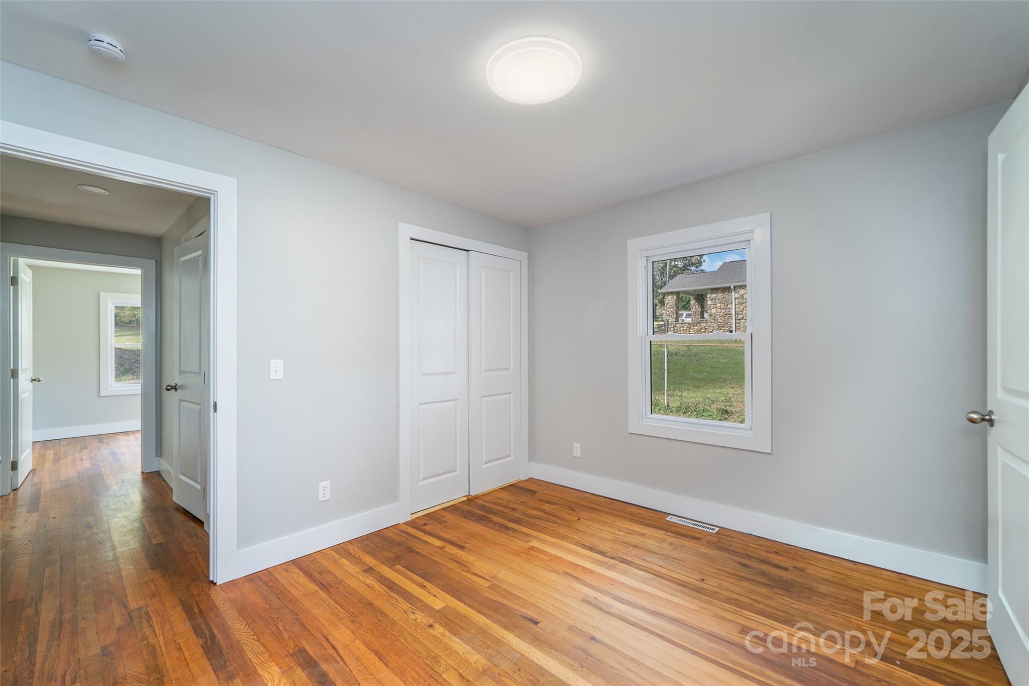 300 Pisgah View Road Asheville, NC 28806 - Photo 19 of 29 a view of empty room with wooden floor and fan