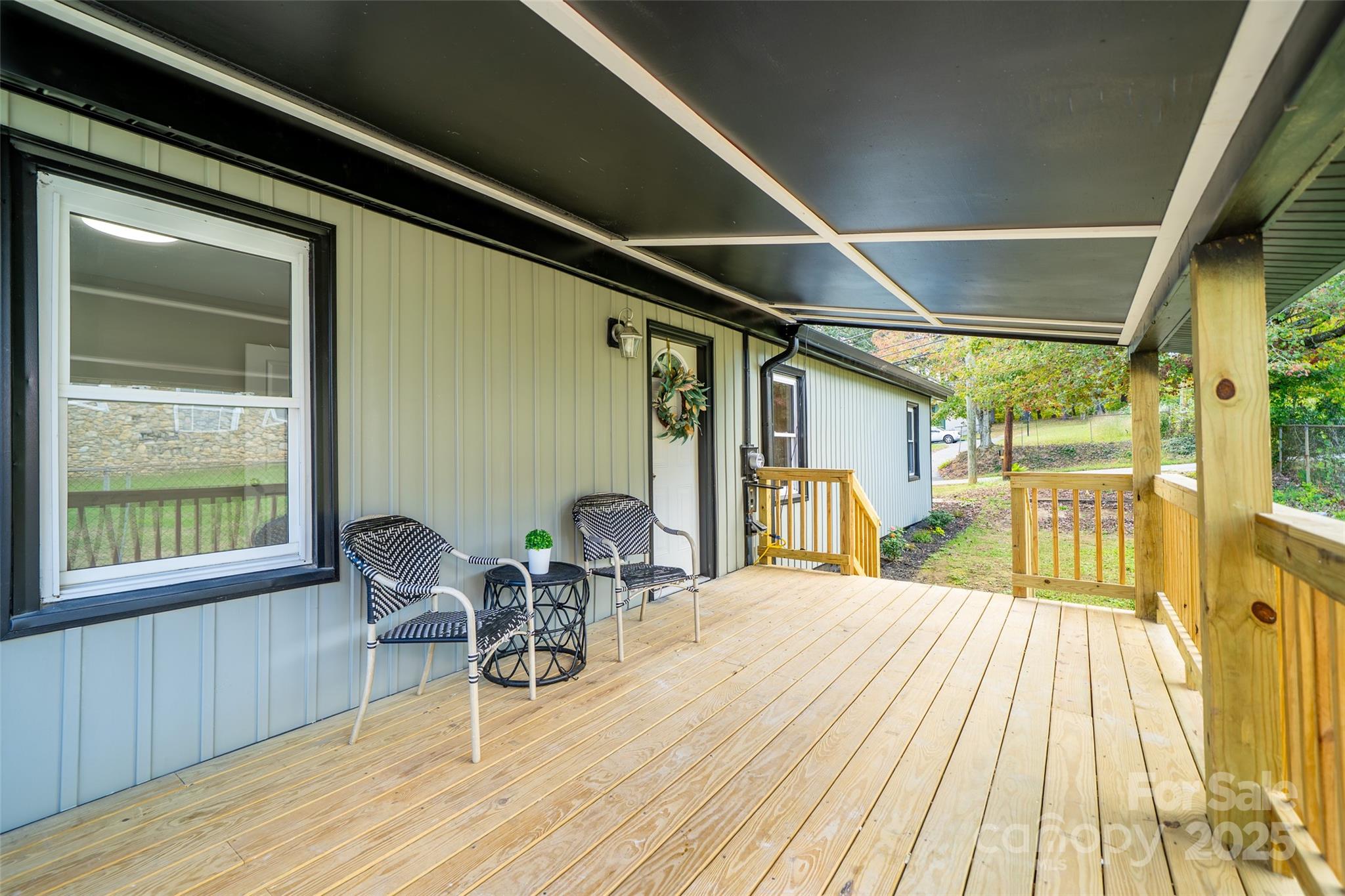 300 Pisgah View Road Asheville, NC 28806 - Photo 24 of 29 a view of a patio with table and chairs and wooden floor