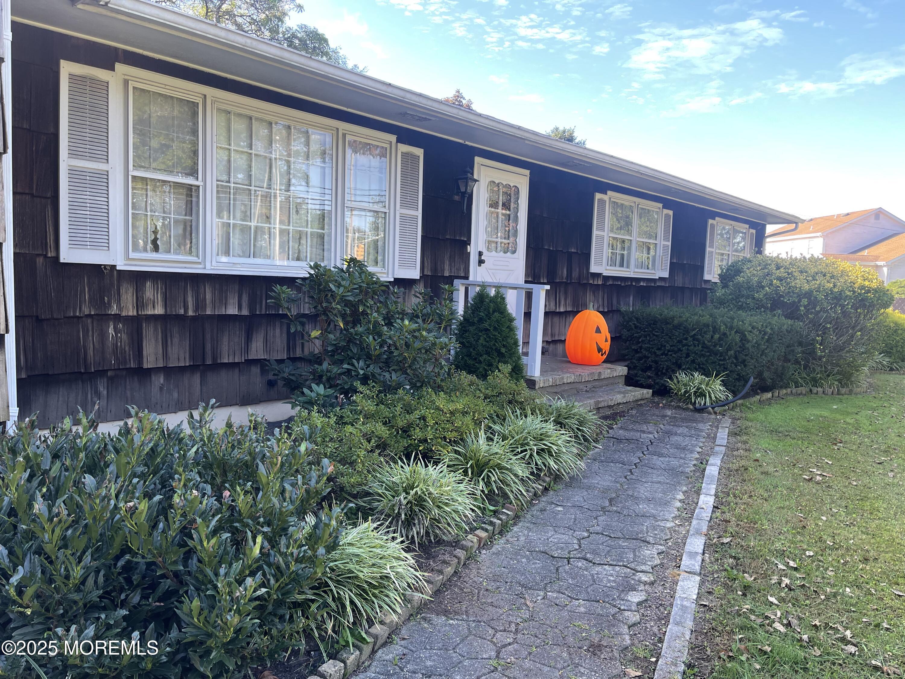 a view of a house with a backyard and garden