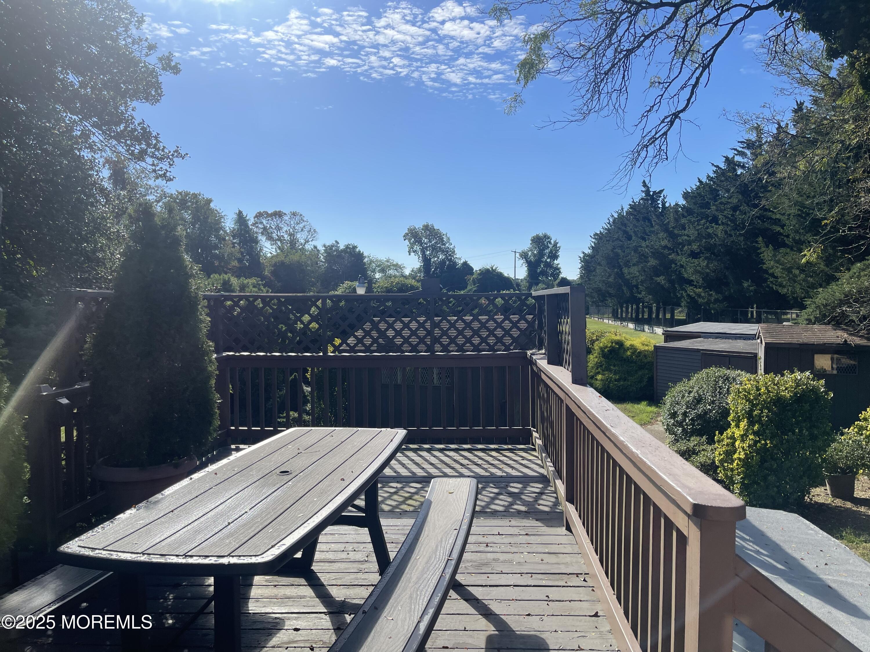 2023 Lanes Mill Road Brick, NJ 08724 - Photo 14 of 40 a view of balcony with wooden floor and outdoor seating