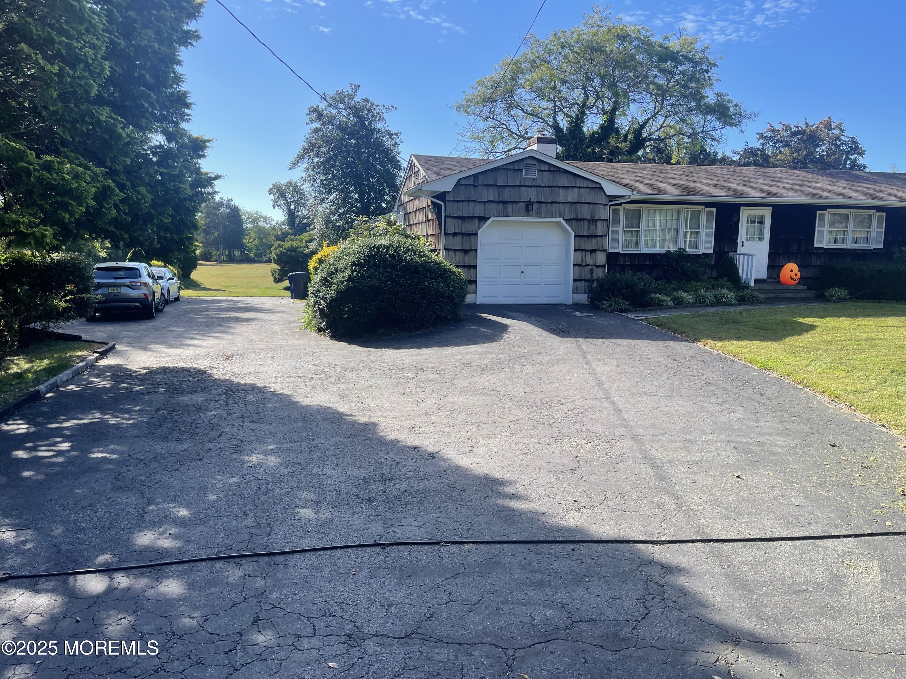2023 Lanes Mill Road Brick, NJ 08724 - Photo 2 of 40 a front view of a house with a yard and a garage