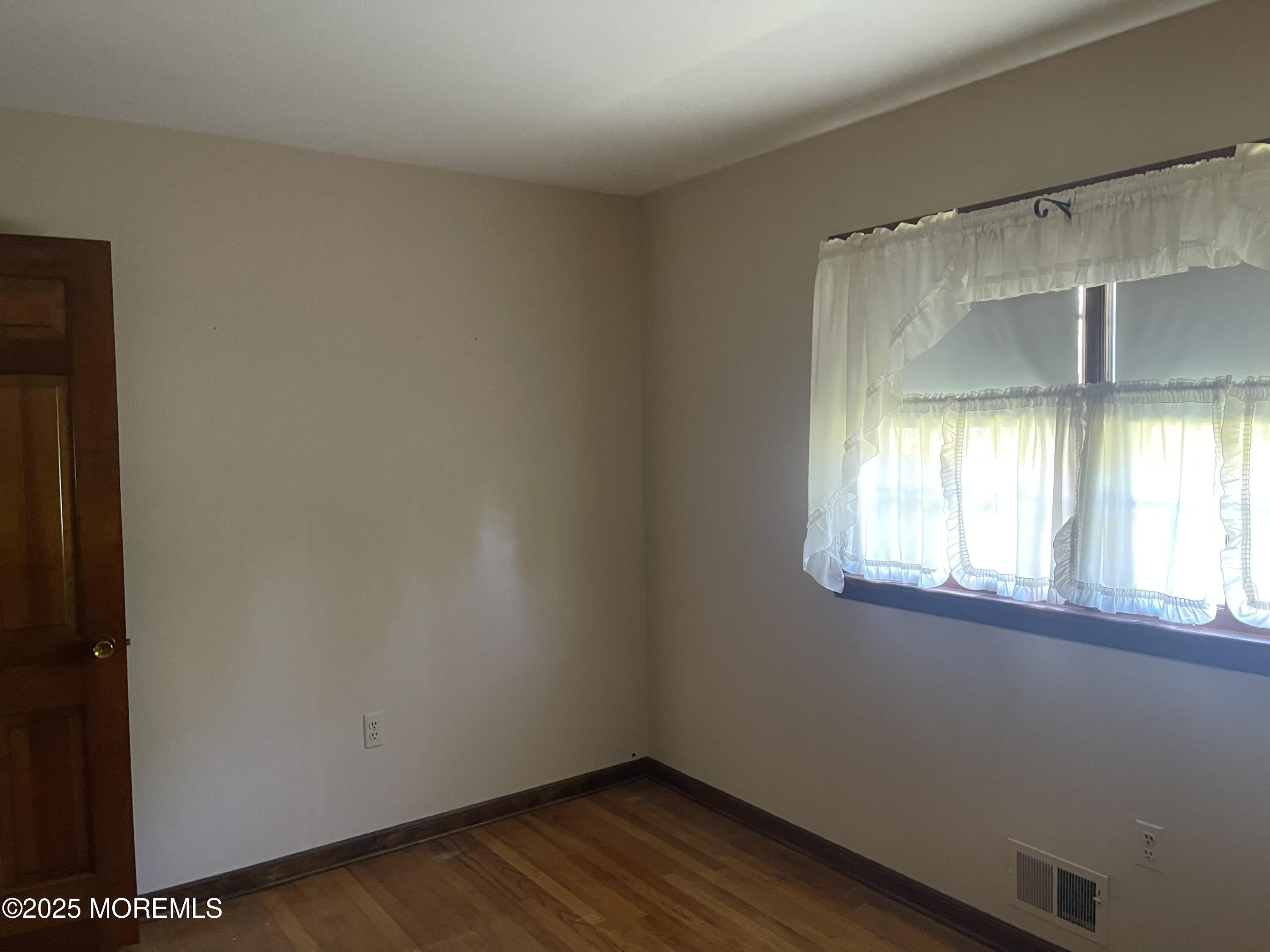2023 Lanes Mill Road Brick, NJ 08724 - Photo 32 of 40 a view of empty room with wooden floor and fan