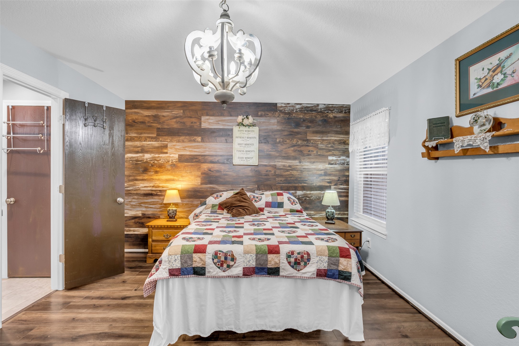 242 Sunset Path North Conroe, TX 77316 - Photo 25 of 37 Chandelier, Feature Wall, and windows lend style and charm to your Primary Suite. 242 SUNSET PATH N - Request your tour today!