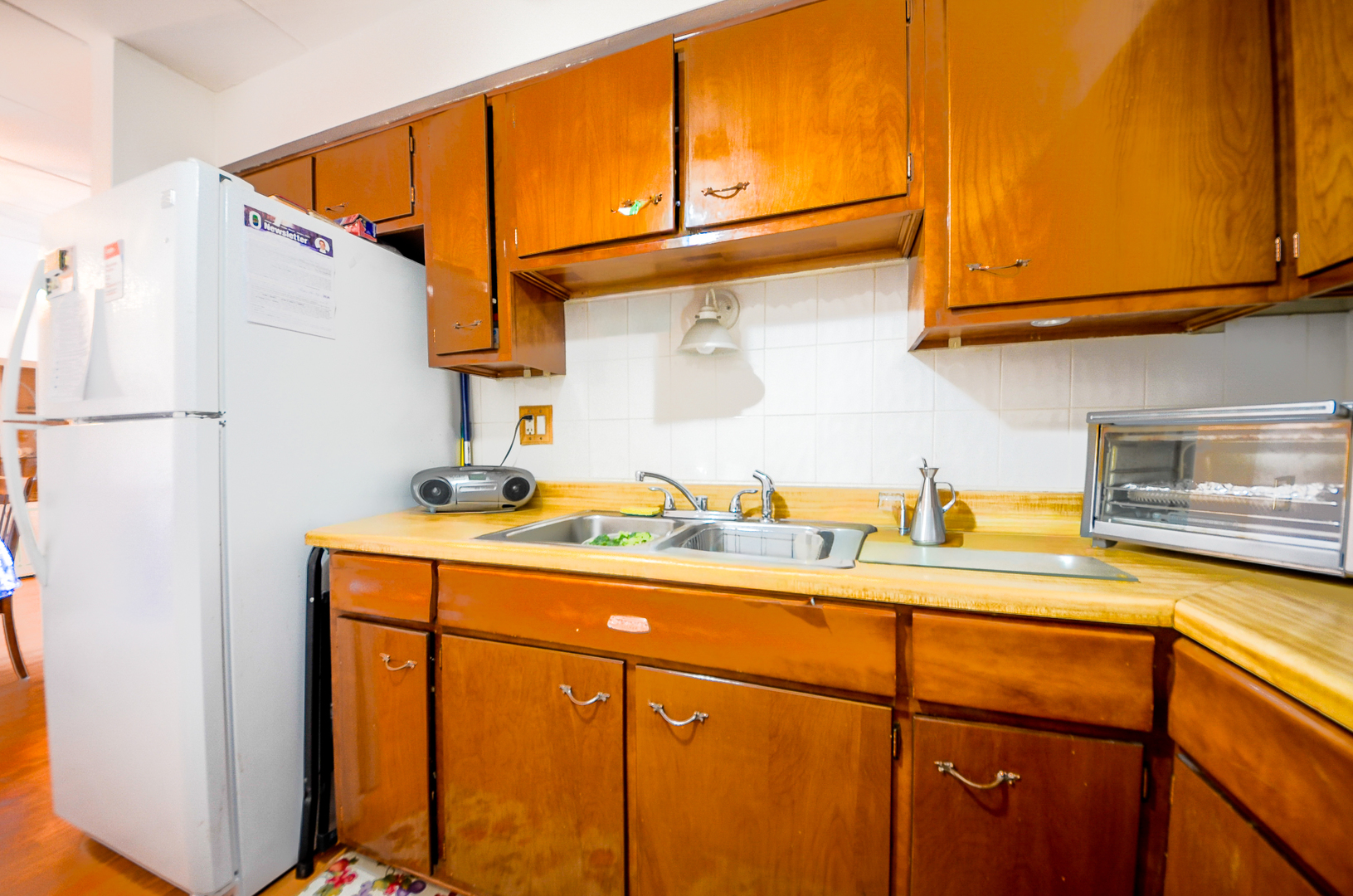 2521 Thatcher Avenue, Unit 2D River Grove, IL 60171 - Photo 6 of 10 a kitchen with a sink a refrigerator and cabinets