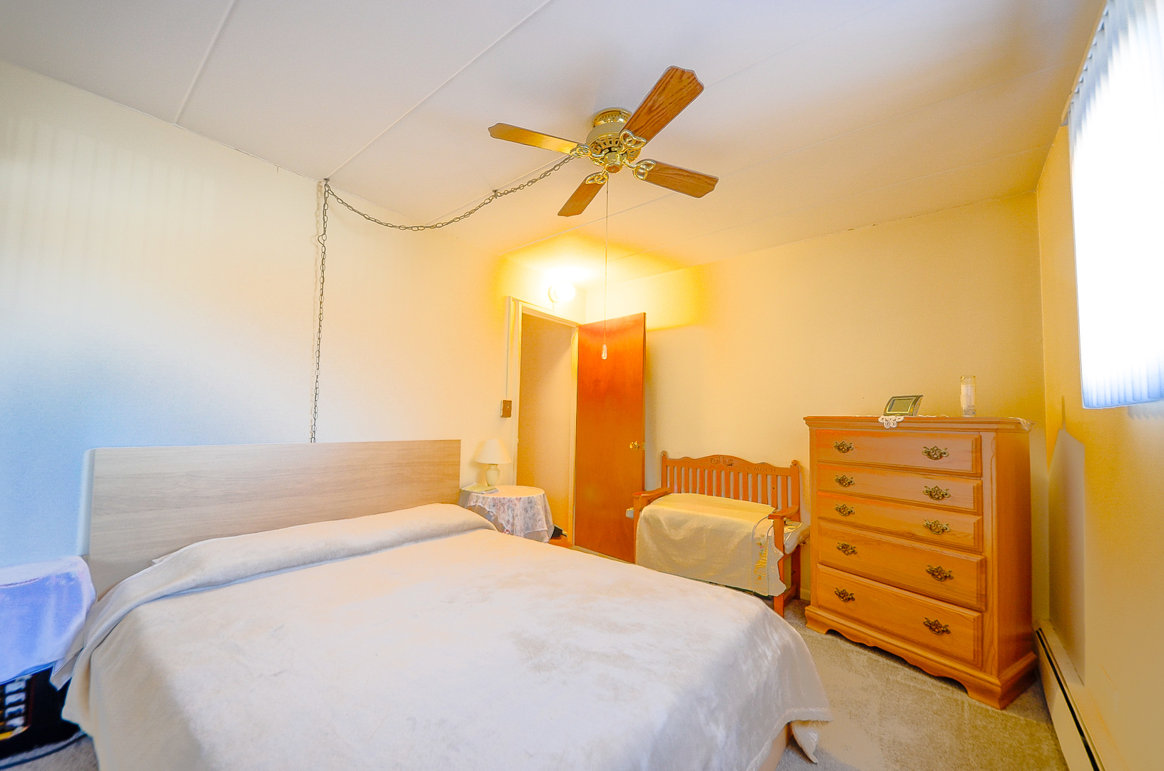 2521 Thatcher Avenue, Unit 2D River Grove, IL 60171 - Photo 7 of 10 a bedroom with a bed and a cabinets