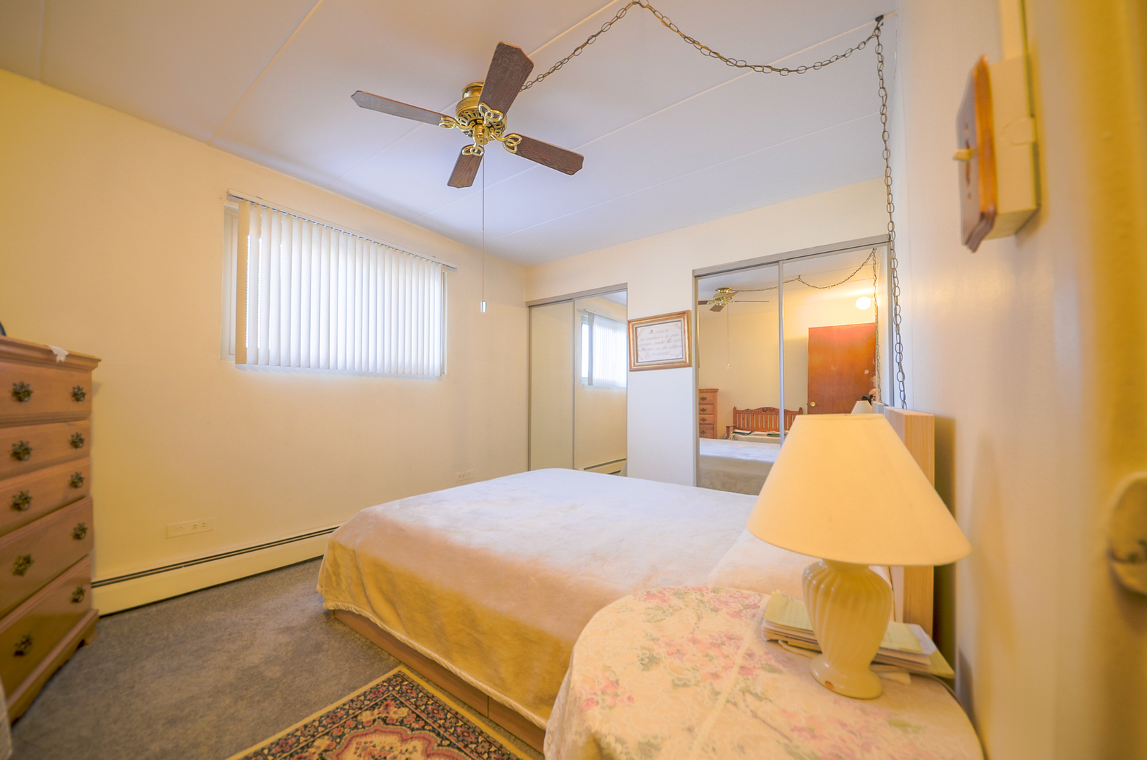 2521 Thatcher Avenue, Unit 2D River Grove, IL 60171 - Photo 8 of 10 a bedroom with a bed and a chandelier