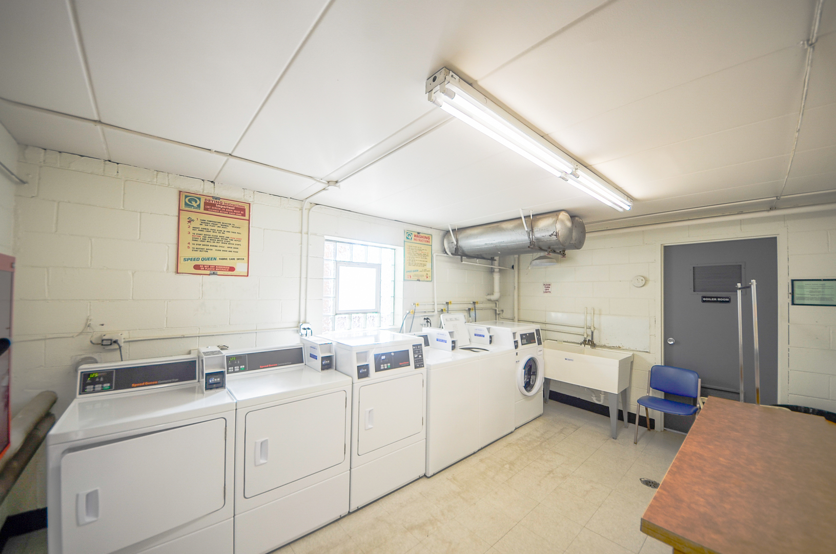2521 Thatcher Avenue, Unit 2D River Grove, IL 60171 - Photo 10 of 10 a kitchen with a sink dishwasher a dining table chairs refrigerator and cabinets