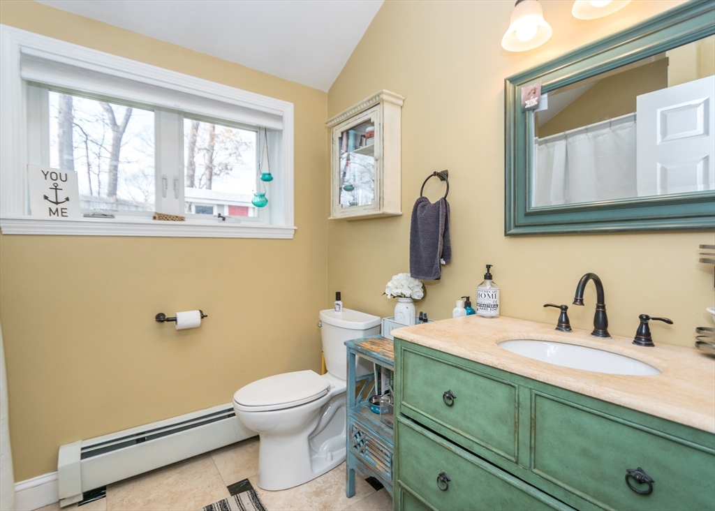 27 Sherman Street Needham, MA 02494 - Photo 13 of 32 a bathroom with a toilet a sink a mirror and a window