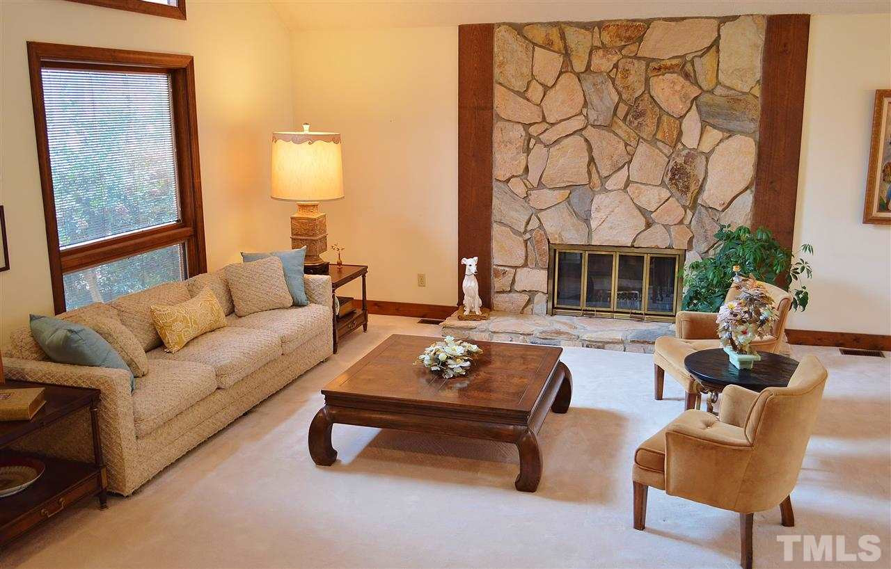 5200 Caber Road Raleigh, NC 27613 - Photo 5 of 25 The living room has a vaulted ceiling, beautiful stone fireplace, and lots of light from all the windows. Living Room