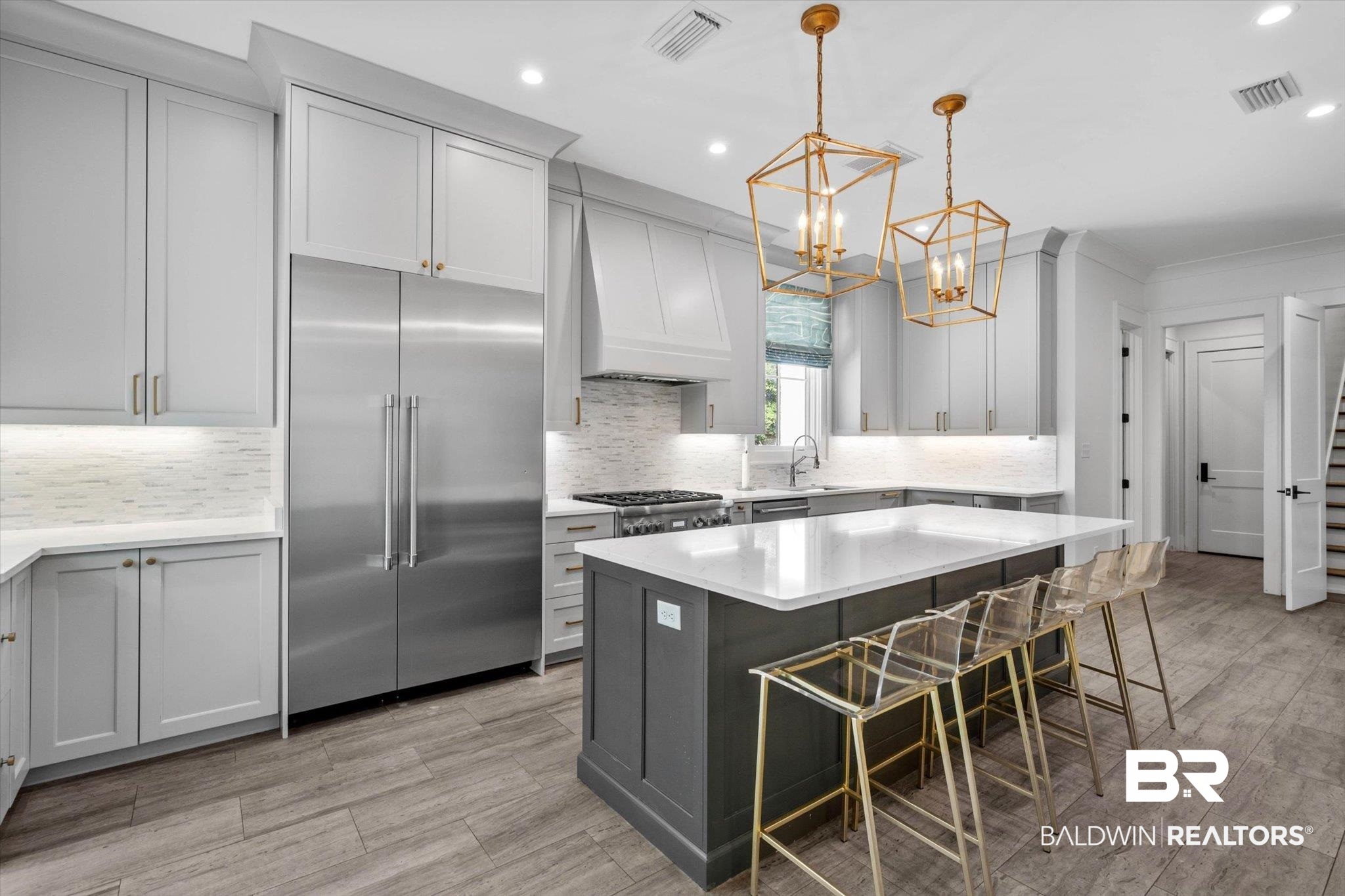 4602 Kingswood Drive Mobile, AL 36608 - Photo 10 of 45 Kitchen featuring a breakfast bar, gray cabinets, stainless steel built in fridge, a center island, and decorative backsplash