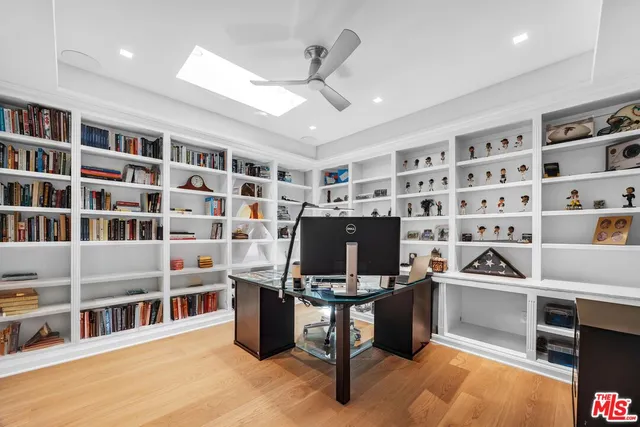 a view of a hallway with wooden floor and a potted plant
