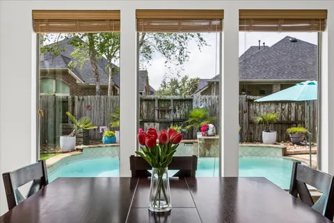 a view of a dining room with furniture window and garden view