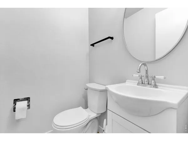 a bathroom with a sink toilet and a mirror