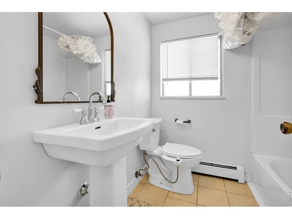 a bathroom with a sink toilet and a mirror