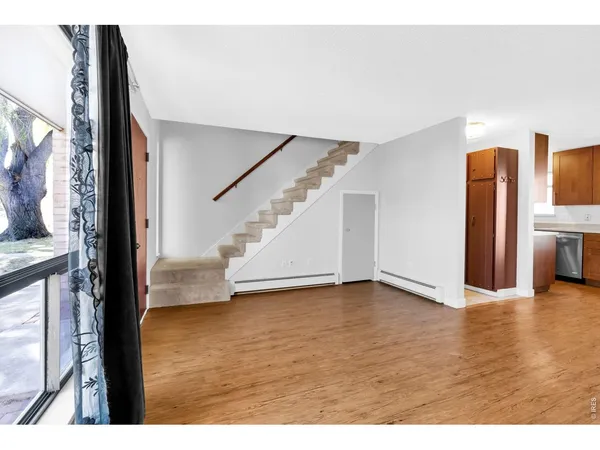 a view of an entryway with wooden floor