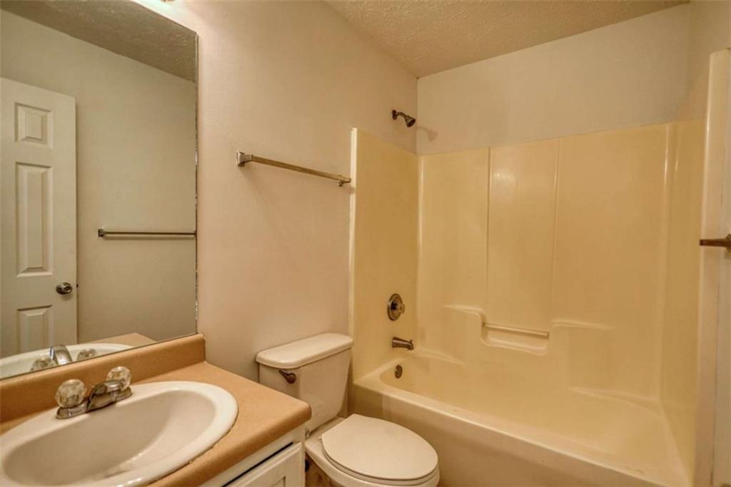 5185 Tew Lane Southwest Covington, GA 30014 - Photo 12 of 42 a bathroom with a sink toilet and shower