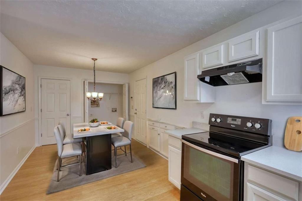 5185 Tew Lane Southwest Covington, GA 30014 - Photo 16 of 42 a kitchen with a stove and cabinets