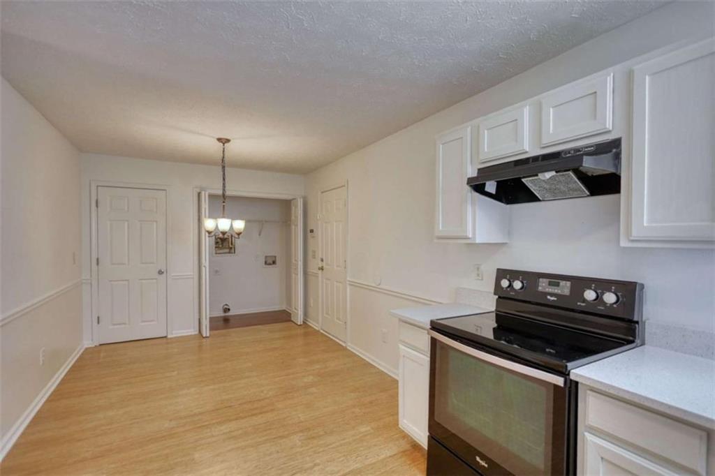 5185 Tew Lane Southwest Covington, GA 30014 - Photo 17 of 42 a kitchen with stainless steel appliances a stove a refrigerator and cabinets