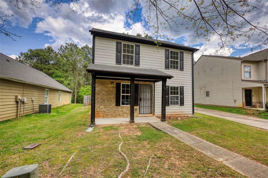 5185 Tew Lane Southwest Covington, GA 30014 - Photo 2 of 42 a front view of a house with a yard