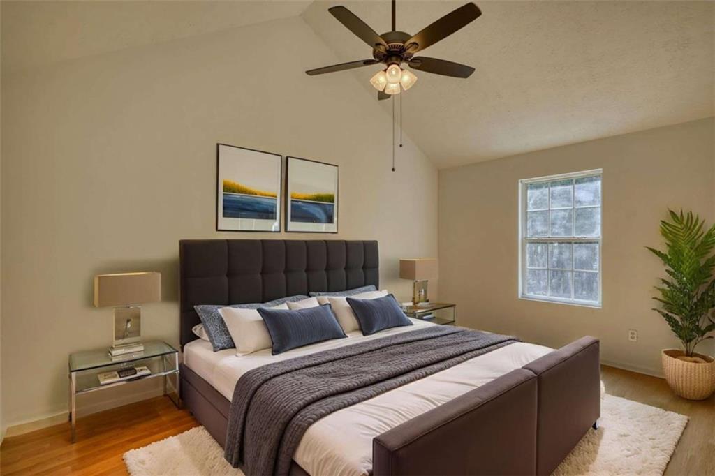 5185 Tew Lane Southwest Covington, GA 30014 - Photo 21 of 42 a bedroom with a bed and a chandelier