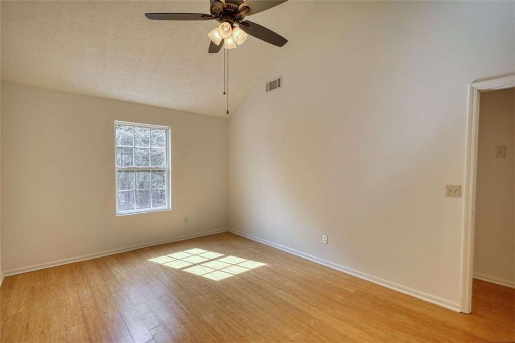 5185 Tew Lane Southwest Covington, GA 30014 - Photo 23 of 42 a view of empty room with wooden floor and fan