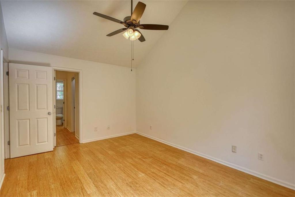 5185 Tew Lane Southwest Covington, GA 30014 - Photo 24 of 42 an empty room with a ceiling fan and wooden floor
