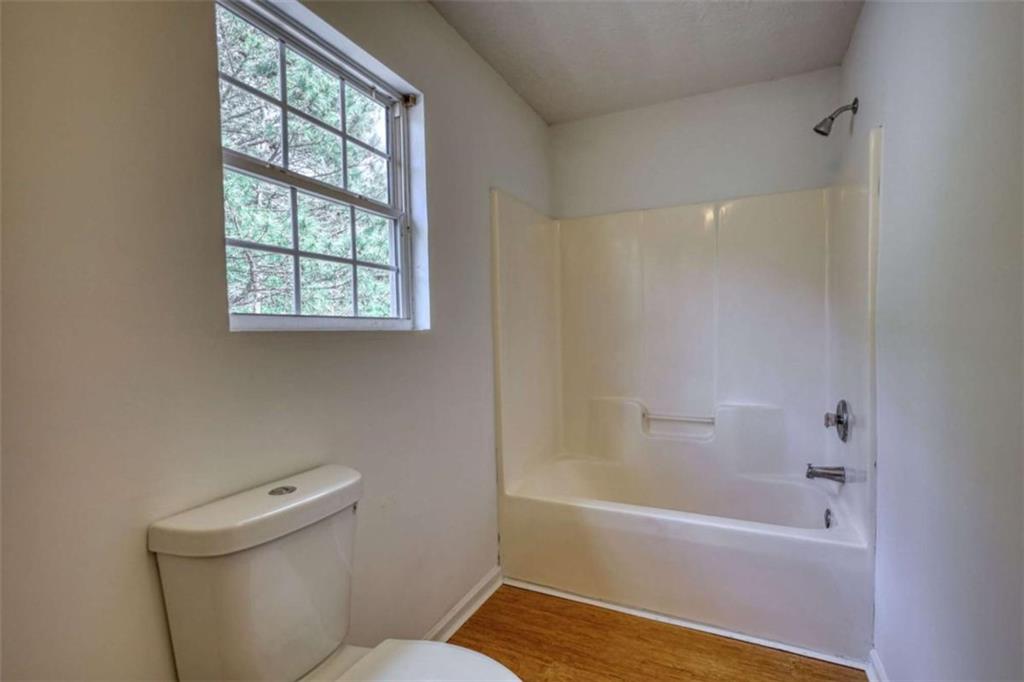 5185 Tew Lane Southwest Covington, GA 30014 - Photo 27 of 42 a bathroom with a bathtub and a toilet