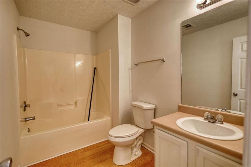 5185 Tew Lane Southwest Covington, GA 30014 - Photo 32 of 42 a bathroom with a sink toilet and shower