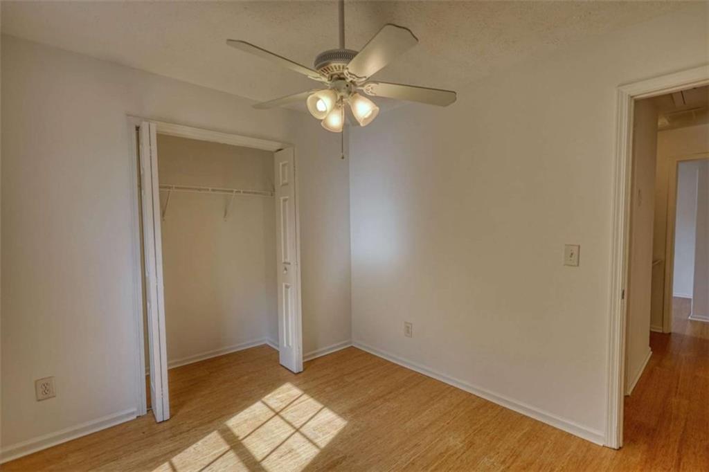 5185 Tew Lane Southwest Covington, GA 30014 - Photo 35 of 42 a view of an empty room with wooden floor and a window