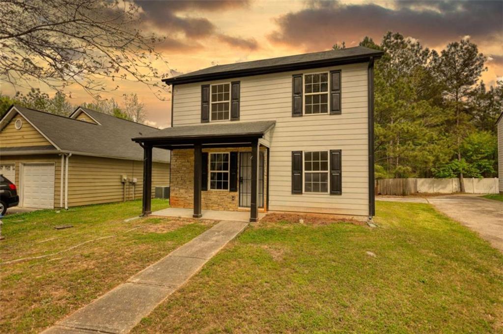 5185 Tew Lane Southwest Covington, GA 30014 - Photo 4 of 42 a front view of a house with a yard