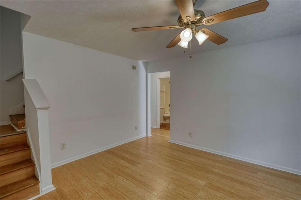 5185 Tew Lane Southwest Covington, GA 30014 - Photo 8 of 42 wooden floor in an empty room with a window