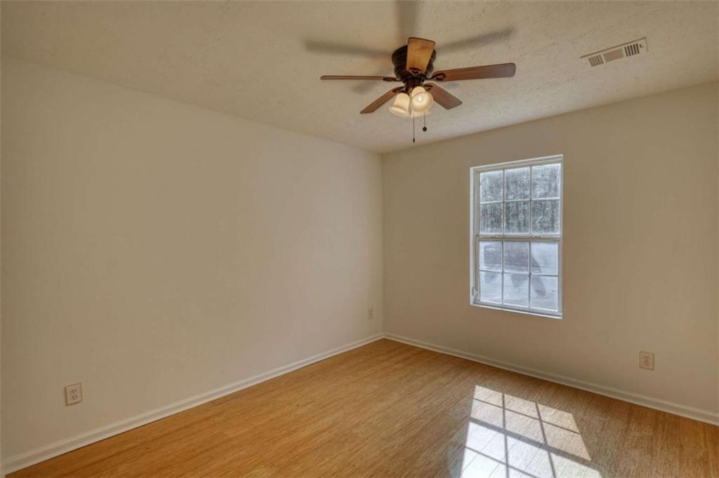 5185 Tew Lane Southwest Covington, GA 30014 - Photo 10 of 42 an empty room with a window and a fan