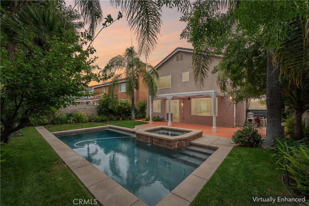 26023 Salinger Lane Stevenson Ranch, CA 91381 - Photo 30 of 35 Virtually enhanced Stunning backyard retreat complete with a sparkling pool, relaxing spa, lush palm trees, and fruit trees